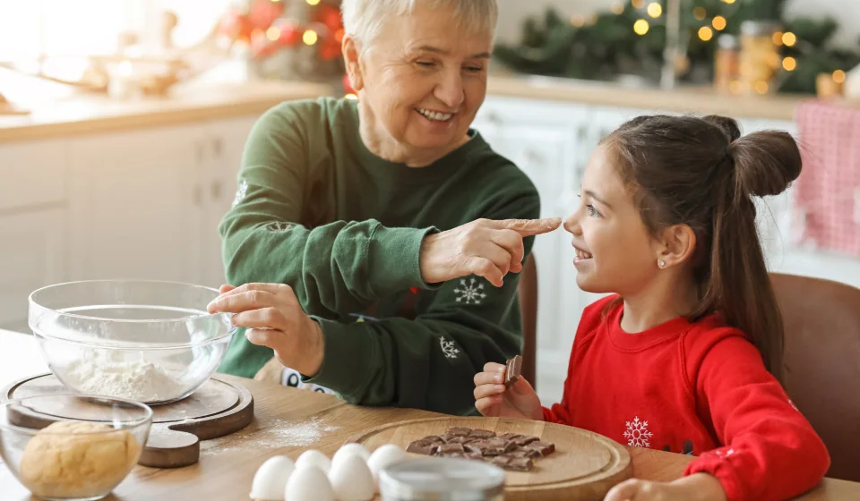 Grandmother baking in the kitchen with her granddaughter
